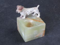 A cold-painted bronze terrier figurine mounted on a green onyx pin dish base.