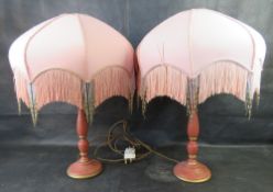 A pair of painted table lamps having gilt decoration and Art Deco style beaded shades.
