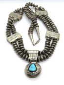 A white metal and turquoise Native American style necklace.