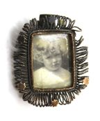 A vintage glazed locket brooch.