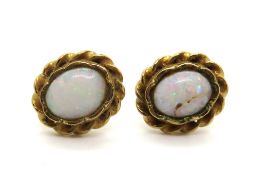 A pair of yellow metal and opal earrings, opal a/f, indistinct hallmark to stud.