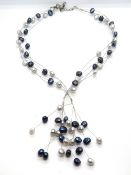 A contemporary coloured pearl and silver necklace.