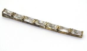 A silver pendant set with white stones,