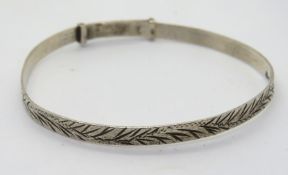 A silver bangle.