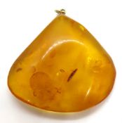 A huge amber pendant having yellow metal loop, approx 5.5 x 5cm without bale.