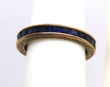 A 9ct gold full eternity ring set with square cut sapphires, hallmarked 375, size M, 2.4g.