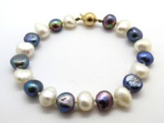 A coloured pearl bracelet having 18ct gold clasp stamped 750.