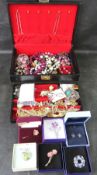 A quantity of costume jewellery within leatherette jewellery box.