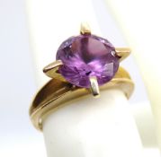 An impressive 9ct gold amethyst cocktail ring, the round cut stone measuring approx 10mm dia x 6.