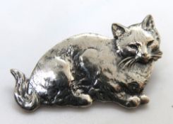 A pewter cat brooch.