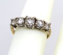 A classic 18ct gold diamond five stone ring, the central round cut diamond approx 5mm dia,