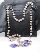 A coloured pearl and amethyst necklace having silver clasp for adjustable length,