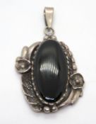 A large silver and black onyx pendant, s