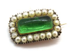 A delightful antique rose metal brooch having central green paste cabachon surrounded by seed
