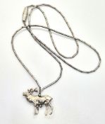 A silver bead necklace having deer penda