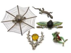 Five animal themed brooches including silver stags head.