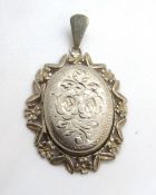 A hallmarked silver locket in extended floral mount, approx 4cm inc bale.