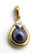 A 9ct gold coloured pearl pendant having diamond in star illusion setting above, stamped 375,