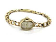 A 9ct gold ladies Accurist wristwatch, on integral 9ct gold strap, hallmarked 375, total weight 10.