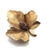 A 9ct gold brooch in the form of a leaf having five small garnets to centre, hallmarked 375,