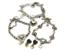 A quantity of designer bracelets, on hallmarked silver, and a similar pair of earrings.