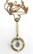 A 9ct gold Edwardian aquamarine and seed pearl pendant on integral chain, stamped 9c to the clasp,