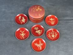 A vintage Japanese red lacquerware set of coasters or small sweet dishes,