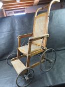 A vintage lightweight collapsible wheelchair.