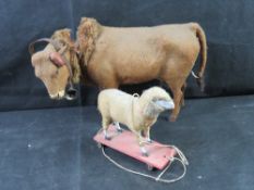 Two antique German pull toys constructed from felt-covered paper mache a/f.