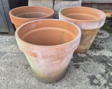 Three matching terracotta pots.