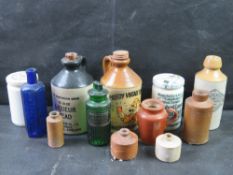 A quantity of salt glazed stoneware pots and glass poison bottles.