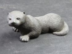 A cold-cast bronze otter pup sculpture by Richard Fisher for Heredities