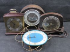 Four vintage clocks including two Smiths examples.