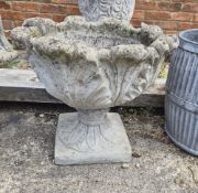 A concrete two part acanthus leaf style flower pot
