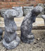 Two concrete garden figurines of otters