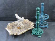 A cast iron boot scraper, paper towel holder and egg holder.