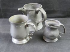 Three pewter tankards.