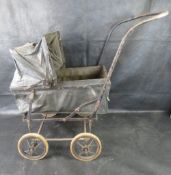 An Edwardian black dolls pram featuring metal frame and a folding hood.