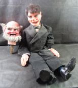 A ventriloquist doll or dummy in classic tuxedo outfit have metal pulls to operate (four controls