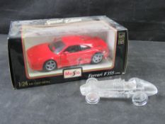 A Maisto Special Edition 1:24 scale die-cast metal model of a red Ferrari F355 in original box.