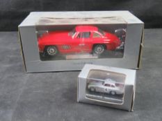 A Bburago 1:24 scale diecast model of a red 1954 Mercedes-Benz 300 SL Gullwing in original box.