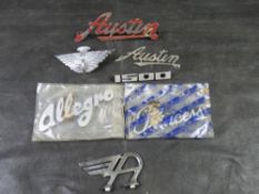 A quantity of assorted plastic and metal Austin car badges including Princess and Allego model