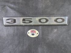 A metal Rover P6 3500 emblem together with an enamelled Rover plaque.