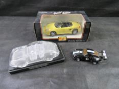 A yellow Maisto 1/24 scale 1996 Porsche Boxster die-cast model car in its original box,