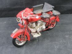 A contemporary metal decorative motorbike with sidecar.