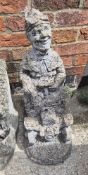 Concrete garden figurine of gnome on a tractor with wagon planter behind.