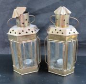 A pair of unusual glazed brass lanterns each standing 28cm high