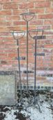 A set of three wrought iron floor standing candle stands.
