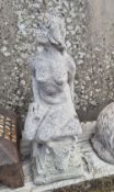 Concrete garden figurine of nude female.