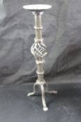 A wrought iron candle stand 42cm high